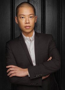 Jason Wu in suit with arms folded